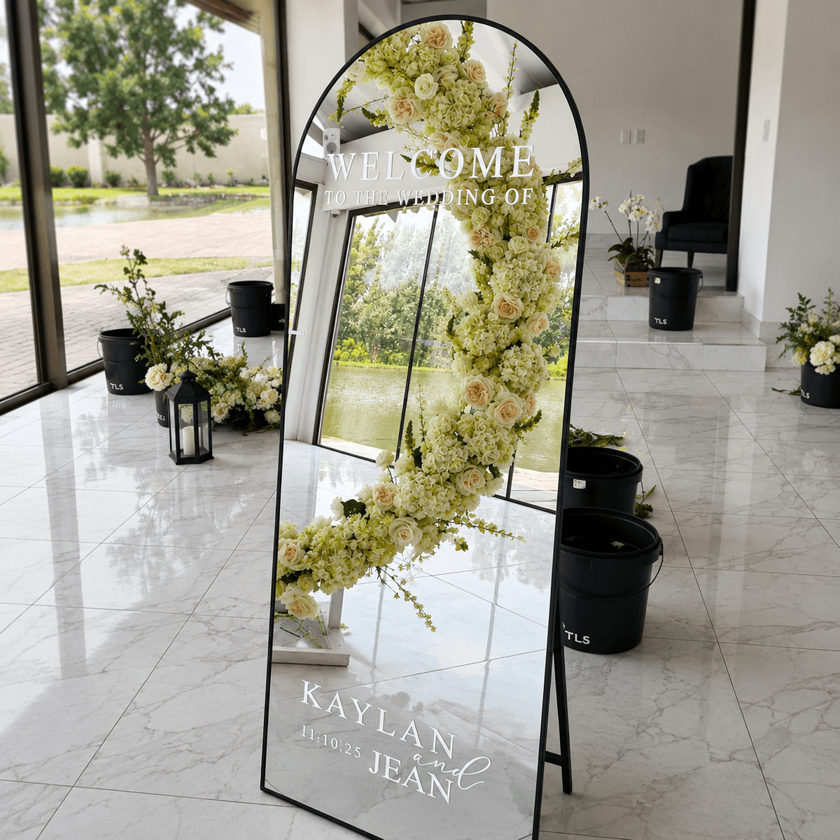 Arched mirror welcome sign with white roses for Kaylan & Jean