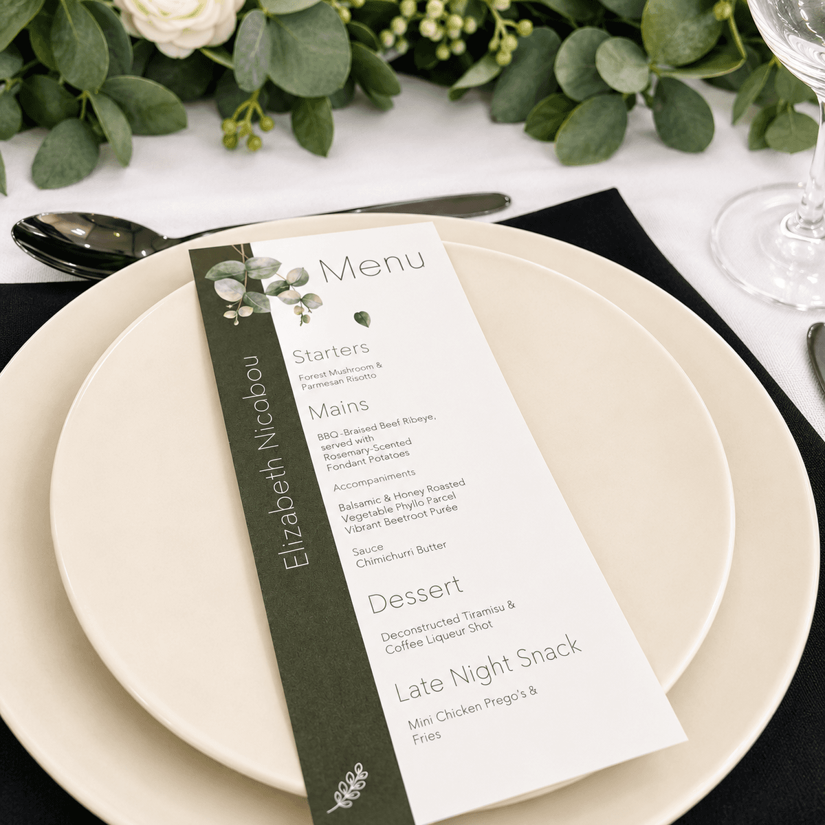 A menu dressed with eucalyptus at an elegant place setting