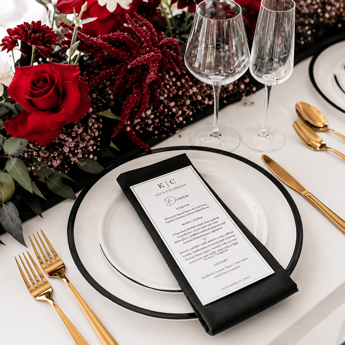 Monogram menu on a black napkin with deep red roses