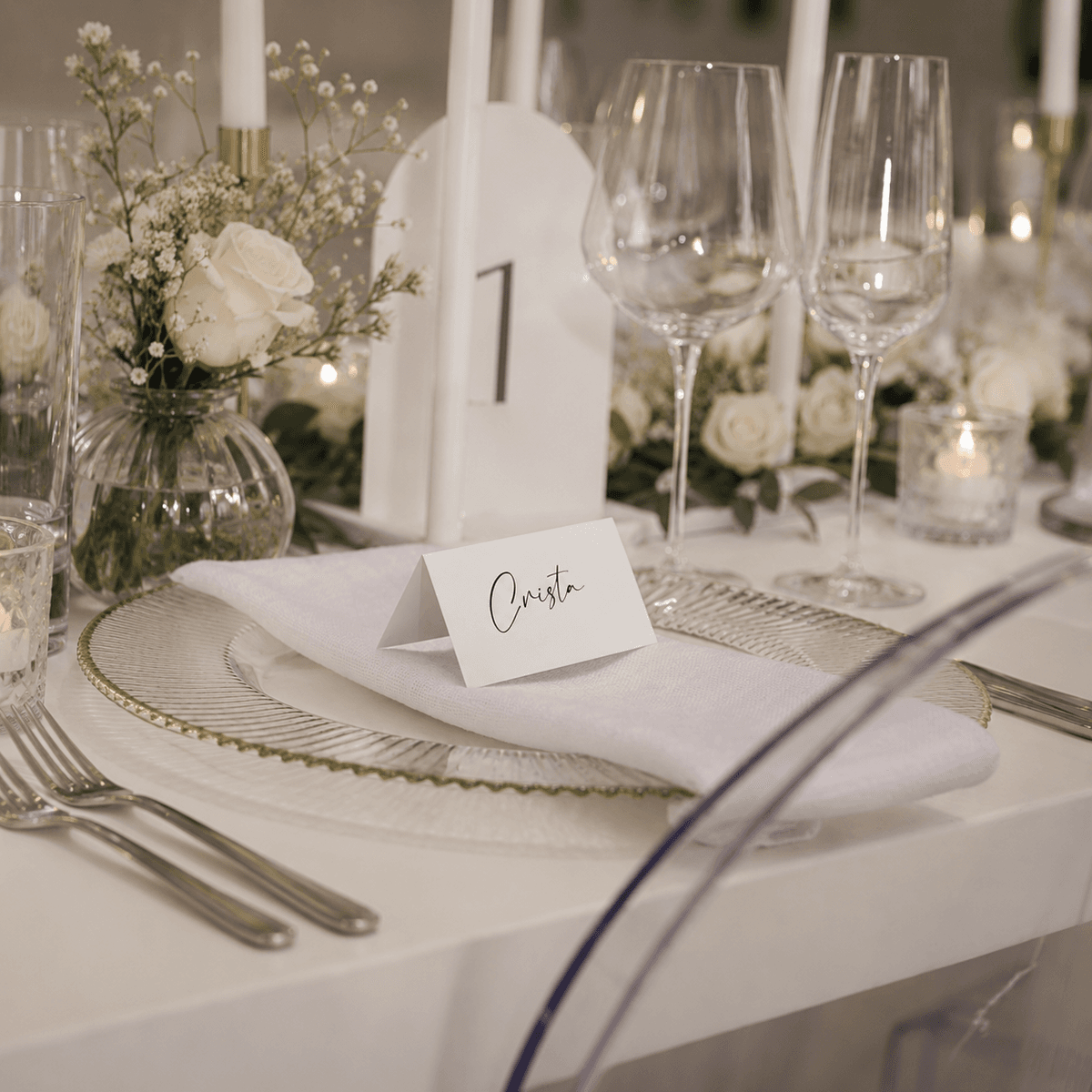 Place card 'Crista' and table number at an elegant place setting