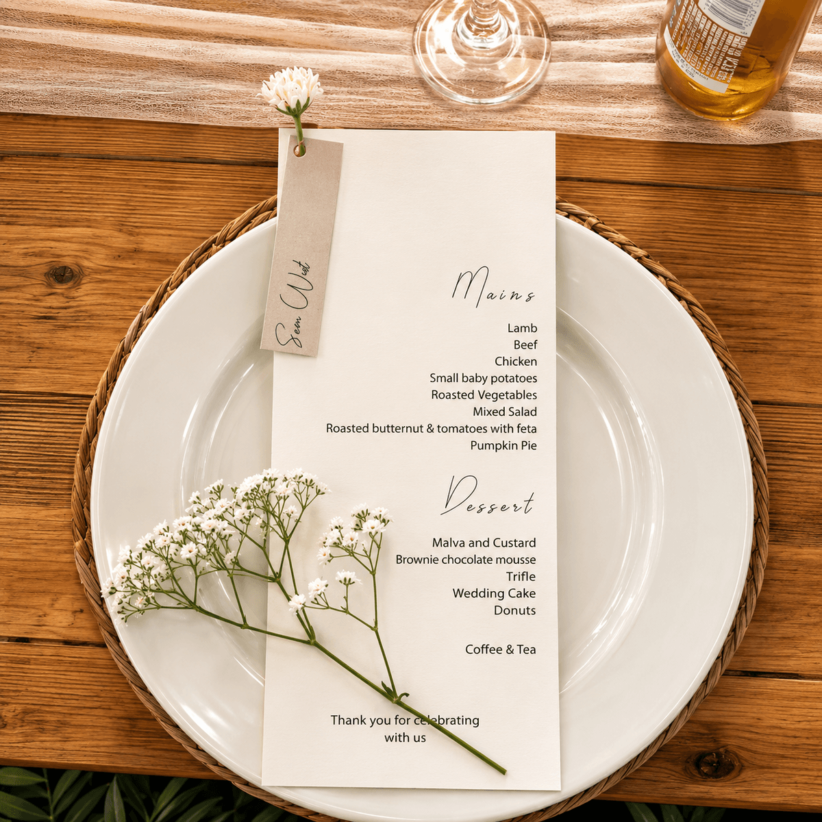 Minimal menu with a name tag and baby's breath on a charger