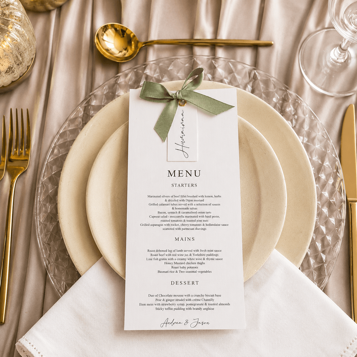Menu with sage ribbon and gold cutlery on a charger plate