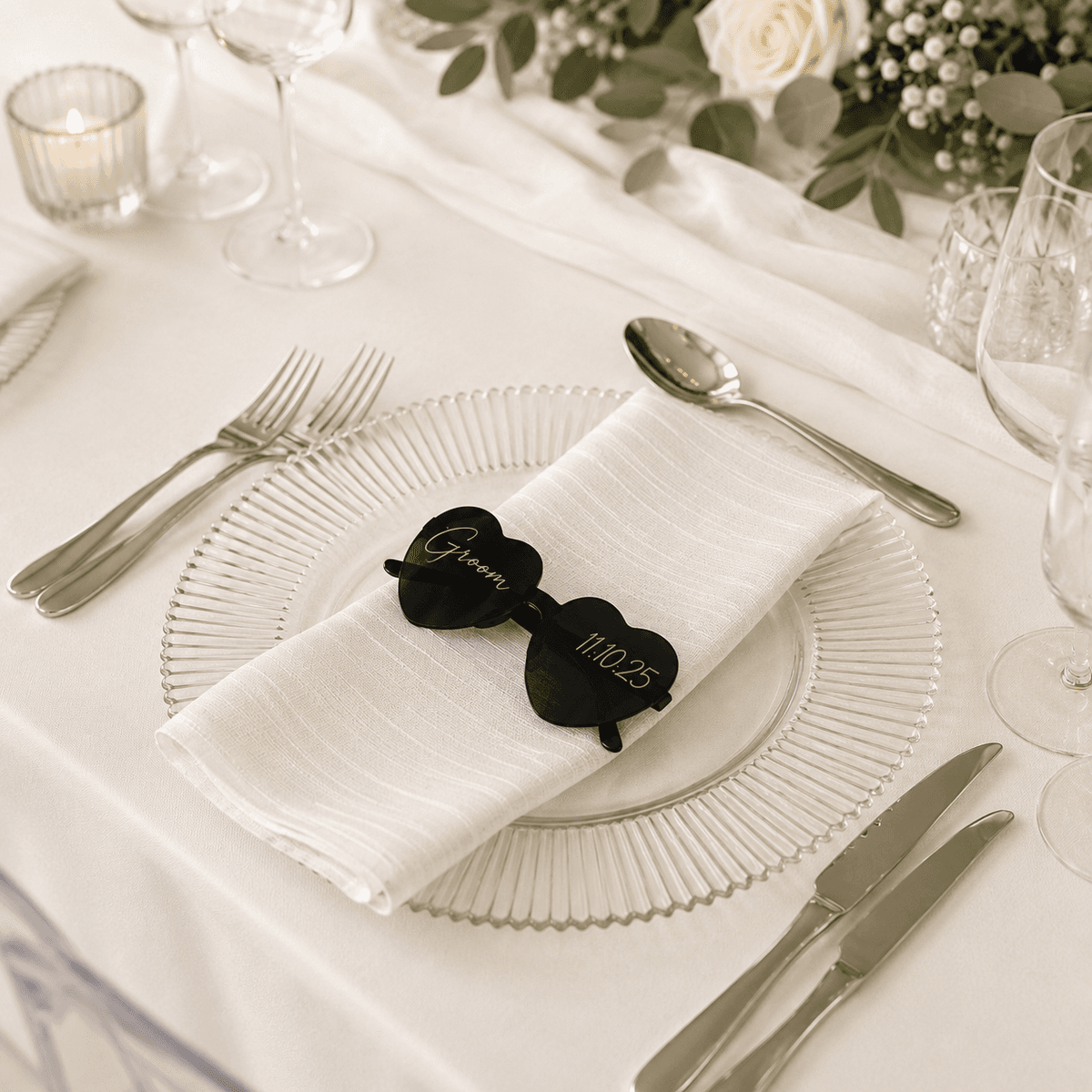 Heart-shaped acrylic place card shaped like sunglasses reading 'Groom'