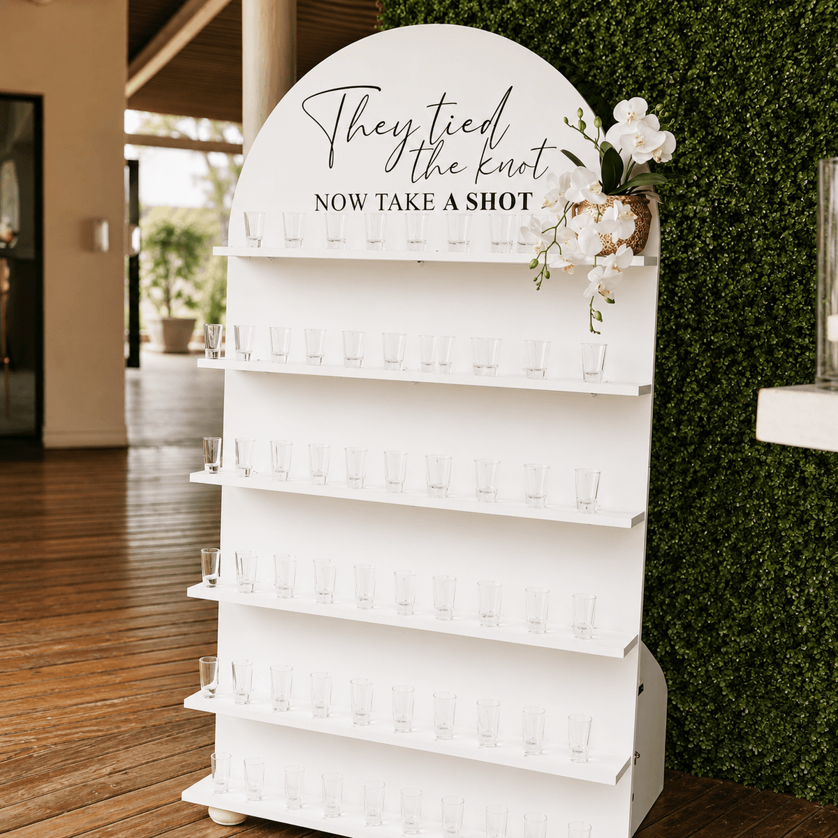 Shot-glass display wall with arched signage